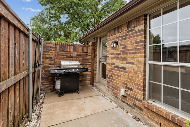 view of patio / terrace featuring grilling area and fence