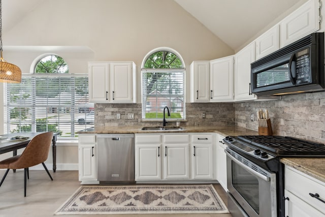 kitchen with a sink, appliances with stainless steel finishes, tasteful backsplash, and plenty of natural light