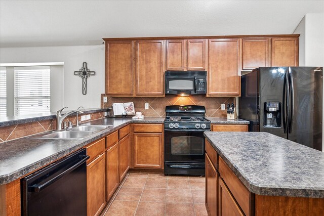 kitchen with a kitchen island, a sink, black appliances, a peninsula, and lofted ceiling
