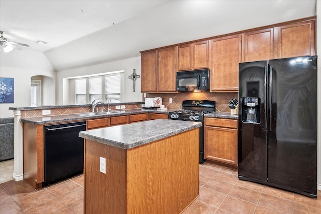 kitchen with a kitchen island, a sink, black appliances, a peninsula, and lofted ceiling