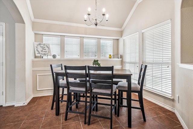 dining room featuring a notable chandelier, arched walkways, dark tile patterned flooring, vaulted ceiling, and ornamental molding