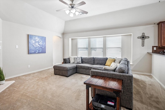 living room with arched walkways, baseboards, ceiling fan with notable chandelier, lofted ceiling, and light carpet