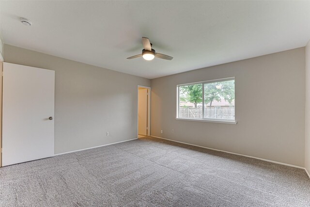 unfurnished room with baseboards, ceiling fan, and carpet flooring