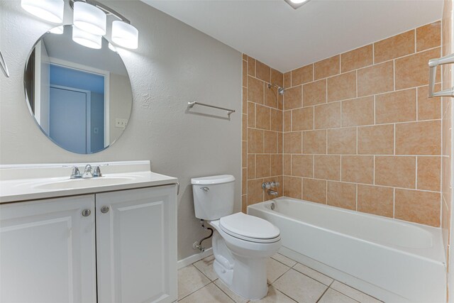 bathroom with shower / bathing tub combination, tile patterned flooring, baseboards, vanity, and toilet