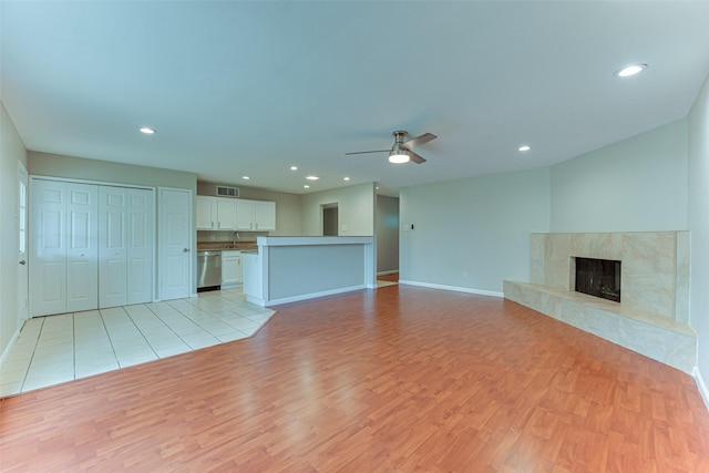 unfurnished living room with baseboards, ceiling fan, light wood finished floors, and visible vents