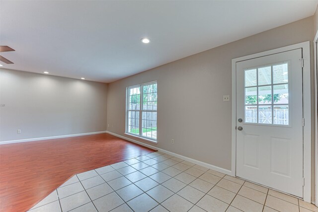doorway with recessed lighting, a ceiling fan, baseboards, and light wood-type flooring