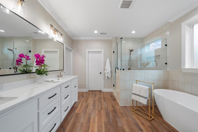 full bathroom with a sink, ornamental molding, a stall shower, and visible vents
