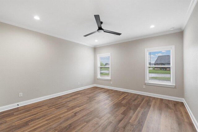 spare room with a ceiling fan, ornamental molding, a wealth of natural light, and dark wood-type flooring