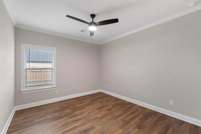 unfurnished room with baseboards, crown molding, and wood finished floors