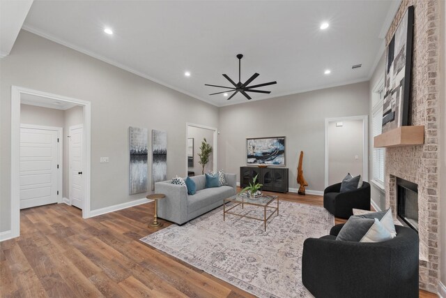 living area with a ceiling fan, baseboards, recessed lighting, and a fireplace