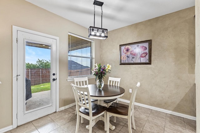 dining room with baseboards and light tile patterned floors