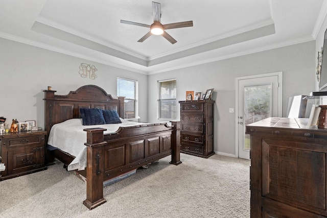 bedroom featuring crown molding, ceiling fan, light carpet, and a raised ceiling