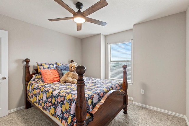 carpeted bedroom featuring baseboards and ceiling fan