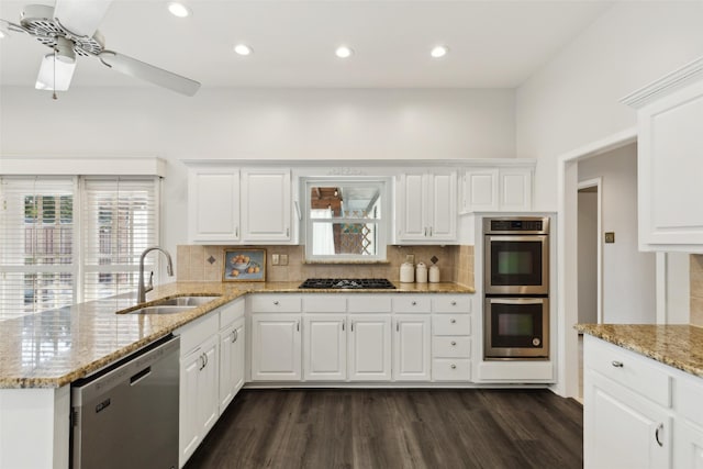 16114 Shadybank Dr, Dallas, TX 75248 - kitchen featuring dark wood-style flooring, a peninsula, a sink, backsplash, and stainless steel appliances