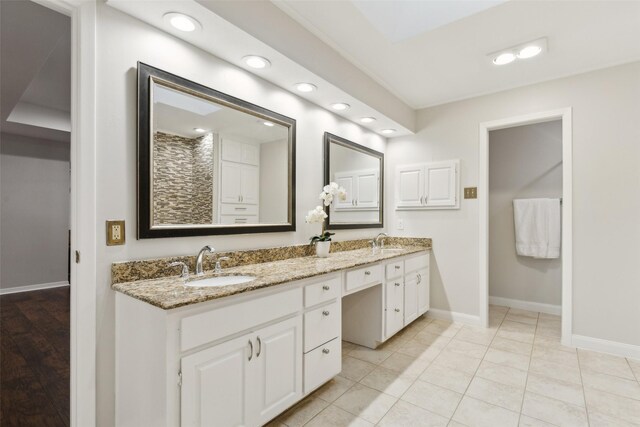 16114 Shadybank Dr, Dallas, TX 75248 - bathroom with double vanity, baseboards, recessed lighting, and a sink