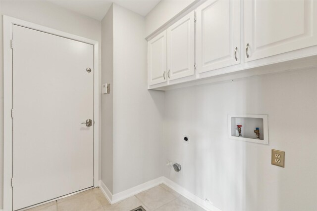 16114 Shadybank Dr, Dallas, TX 75248 - laundry room featuring washer hookup, electric dryer hookup, cabinet space, light tile patterned floors, and baseboards