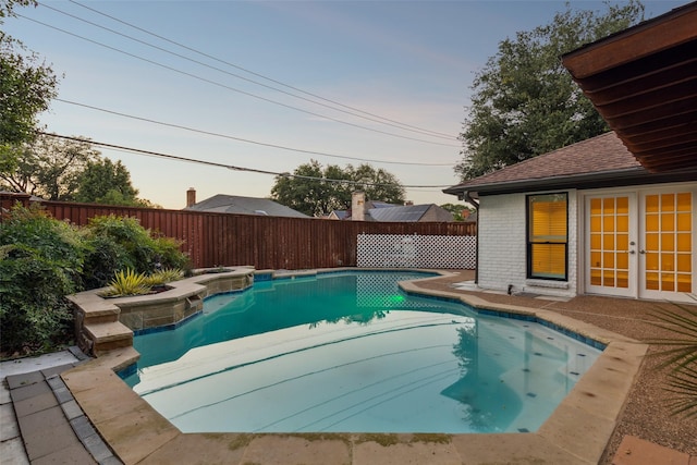 16114 Shadybank Dr, Dallas, TX 75248 - pool at dusk featuring a fenced in pool, french doors, and a fenced backyard