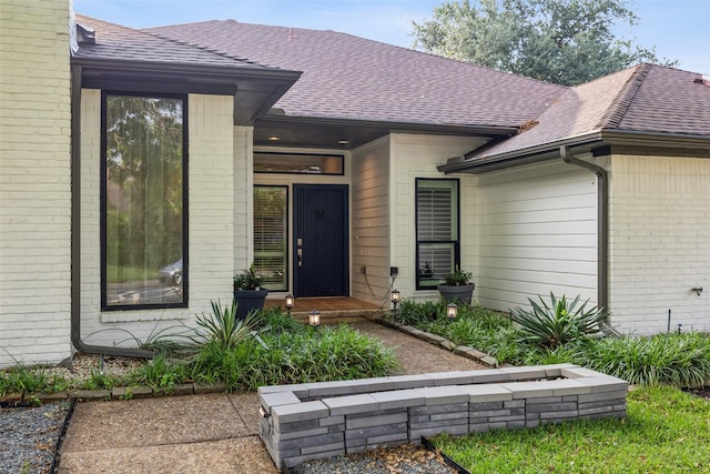 16114 Shadybank Dr, Dallas, TX 75248 - view of exterior entry featuring a shingled roof and brick siding