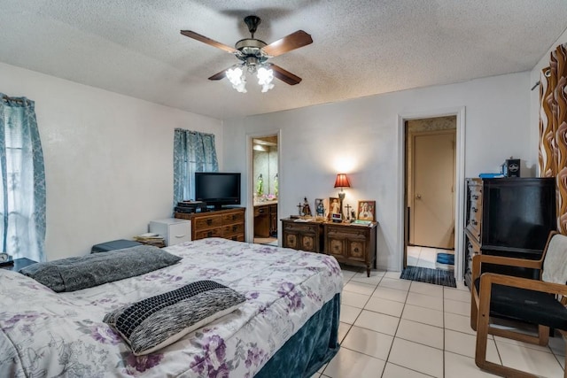 bedroom with a textured ceiling, ceiling fan, and light tile patterned flooring