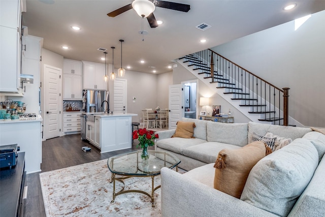 8210 Laflin Ln, Dallas, TX 75231 - living area with dark wood-style flooring, ceiling fan, stairway, and recessed lighting
