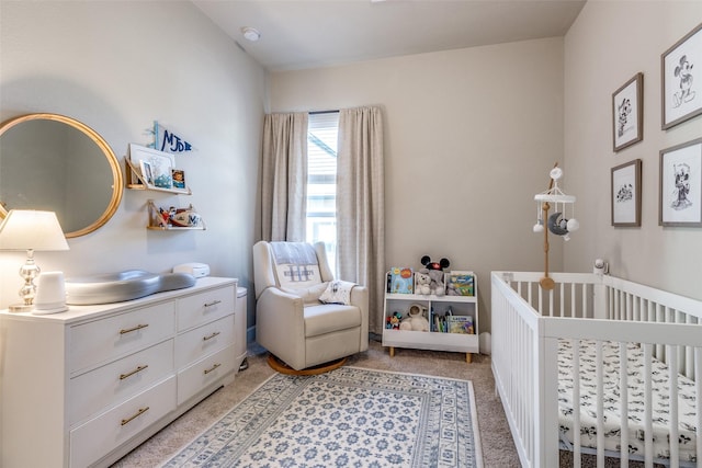 8210 Laflin Ln, Dallas, TX 75231 - bedroom featuring a nursery area and light carpet