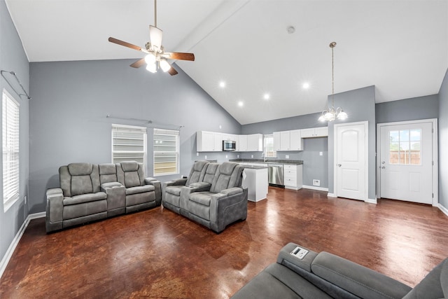 living room with baseboards, recessed lighting, ceiling fan with notable chandelier, and high vaulted ceiling