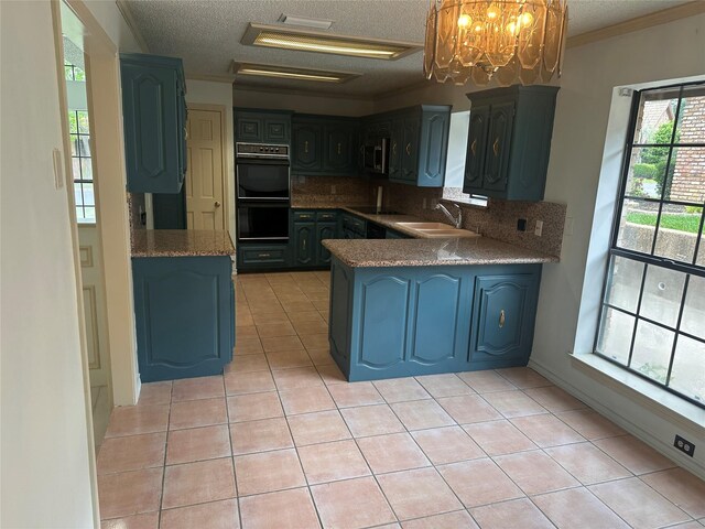 kitchen with dobule oven black, a textured ceiling, a sink, backsplash, and light tile patterned floors
