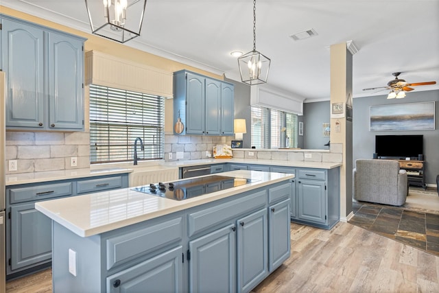 kitchen with visible vents, ornamental molding, a kitchen island, black electric stovetop, and blue cabinets