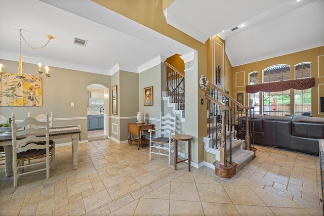 interior space with visible vents, crown molding, arched walkways, stairway, and stone tile flooring