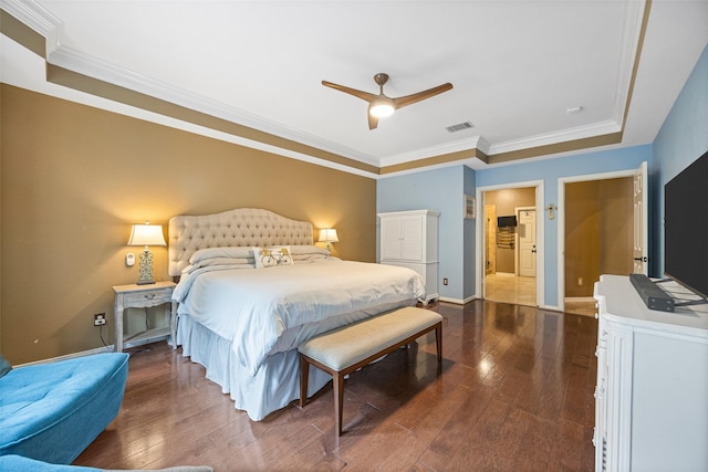 bedroom featuring visible vents, ornamental molding, baseboards, and dark wood-type flooring