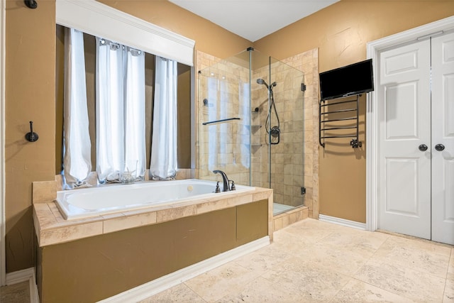 bathroom with baseboards, a stall shower, and a bath