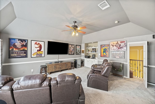 living room with a ceiling fan, vaulted ceiling, light carpet, and visible vents