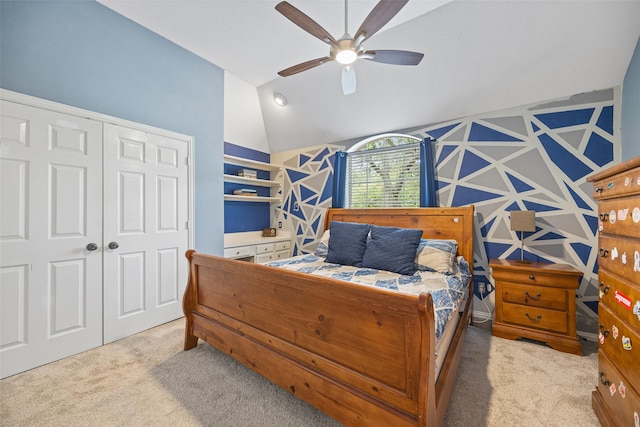 bedroom featuring ceiling fan, light colored carpet, lofted ceiling, and a closet