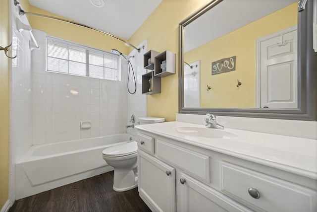 full bath featuring bathing tub / shower combination, vanity, toilet, and wood finished floors