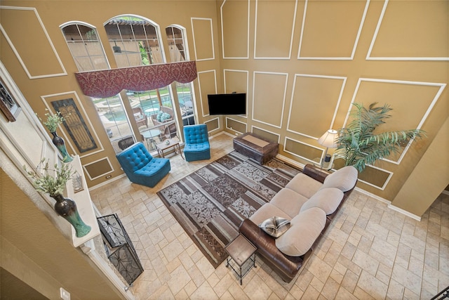 living area featuring brick floor and a decorative wall