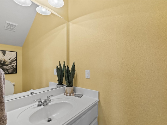 1646 Country Hls, Waxahachie, TX 75165 - half bathroom with visible vents, vaulted ceiling, toilet, and vanity