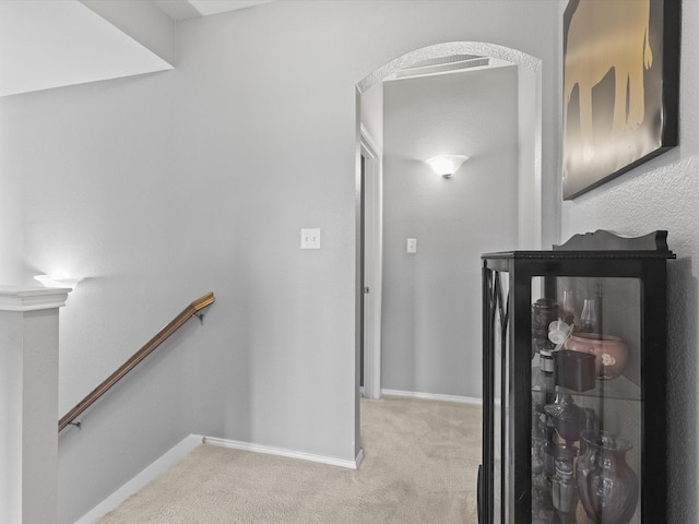1646 Country Hls, Waxahachie, TX 75165 - hallway featuring carpet floors, arched walkways, baseboards, and an upstairs landing