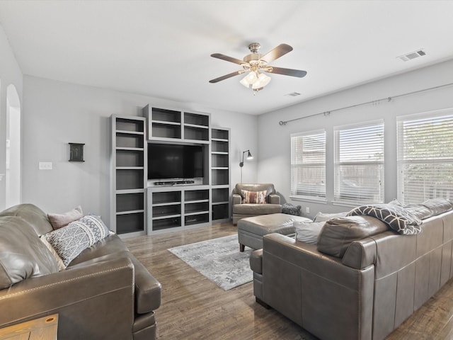 1646 Country Hls, Waxahachie, TX 75165 - living room featuring arched walkways, ceiling fan, visible vents, and wood finished floors