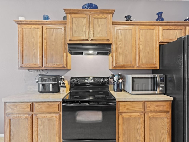 1646 Country Hls, Waxahachie, TX 75165 - kitchen with tile patterned flooring, light countertops, ventilation hood, and black appliances