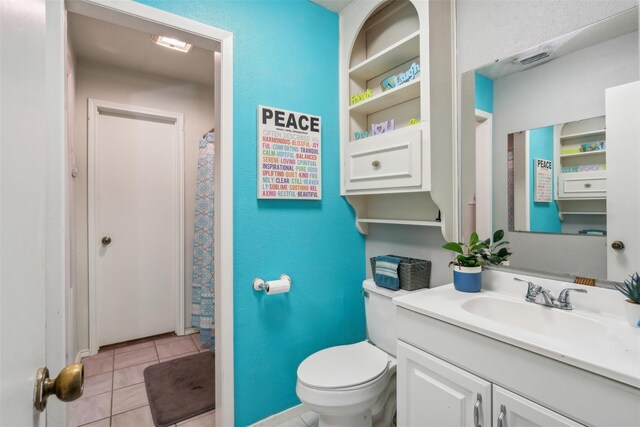 bathroom featuring toilet, tile patterned floors, visible vents, and vanity