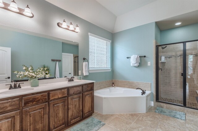 bathroom featuring double vanity, a sink, a garden tub, and a stall shower