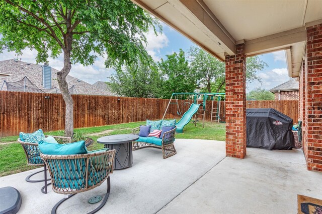 view of patio with a fenced backyard, a playground, and a grill