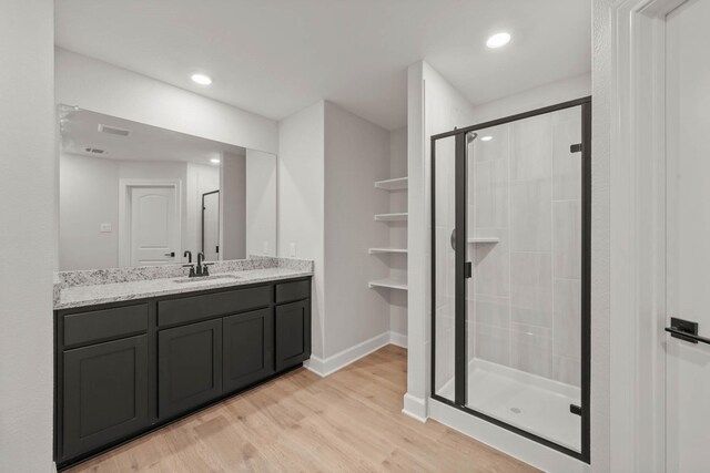 1105 Dye Blvd, Princeton, TX 75407 - bathroom with vanity, a stall shower, wood finished floors, and visible vents