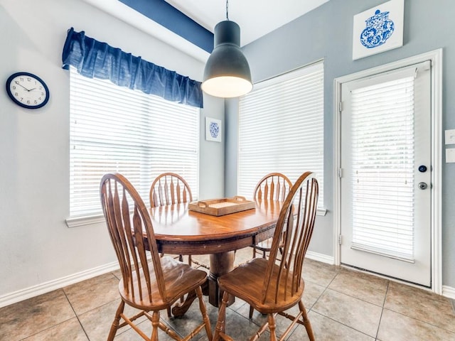 dining space with light tile patterned flooring and baseboards