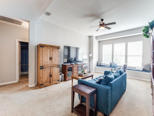 living room with visible vents, ceiling fan, and light colored carpet