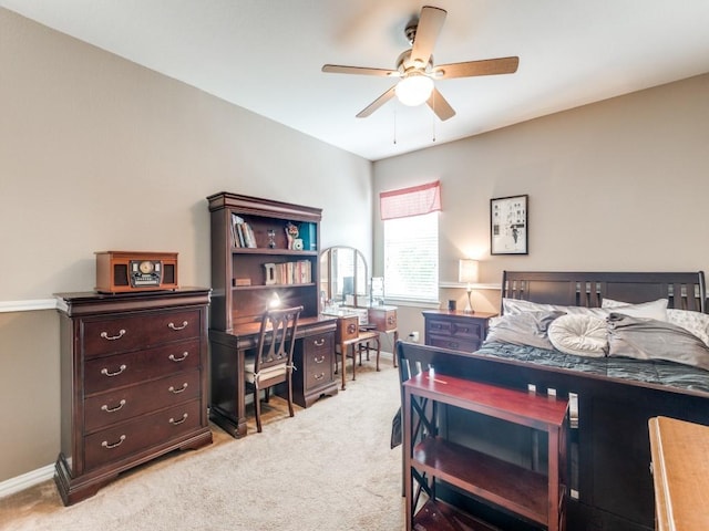 bedroom with light colored carpet, a ceiling fan, and baseboards