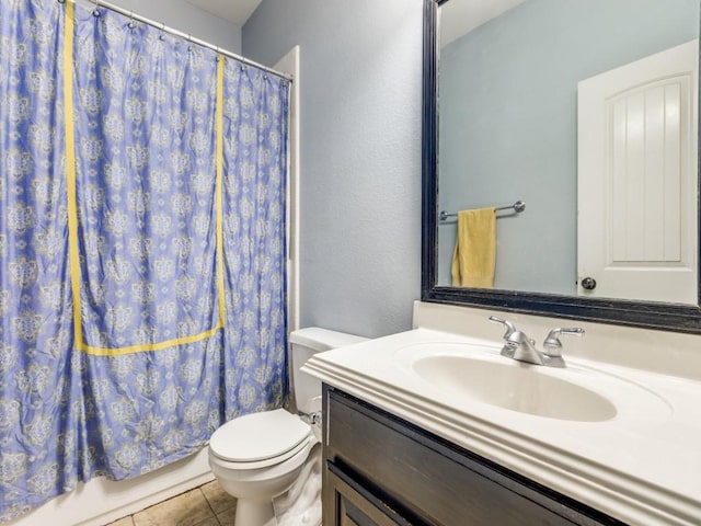 bathroom featuring tile patterned floors, vanity, and toilet