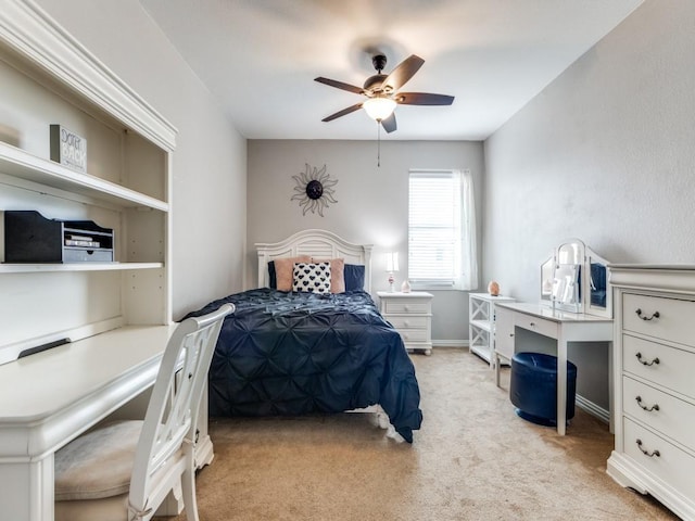 bedroom featuring a ceiling fan and light colored carpet