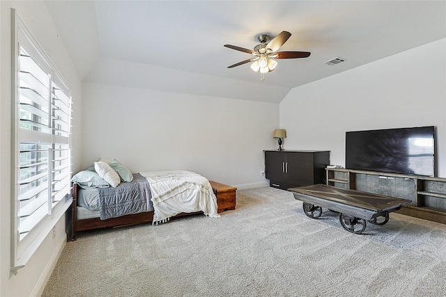bedroom featuring carpet floors, lofted ceiling, baseboards, and a ceiling fan
