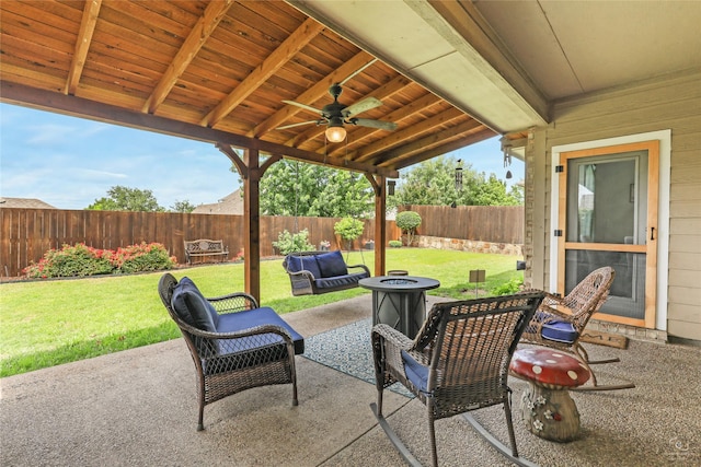 view of patio featuring ceiling fan and a fire pit